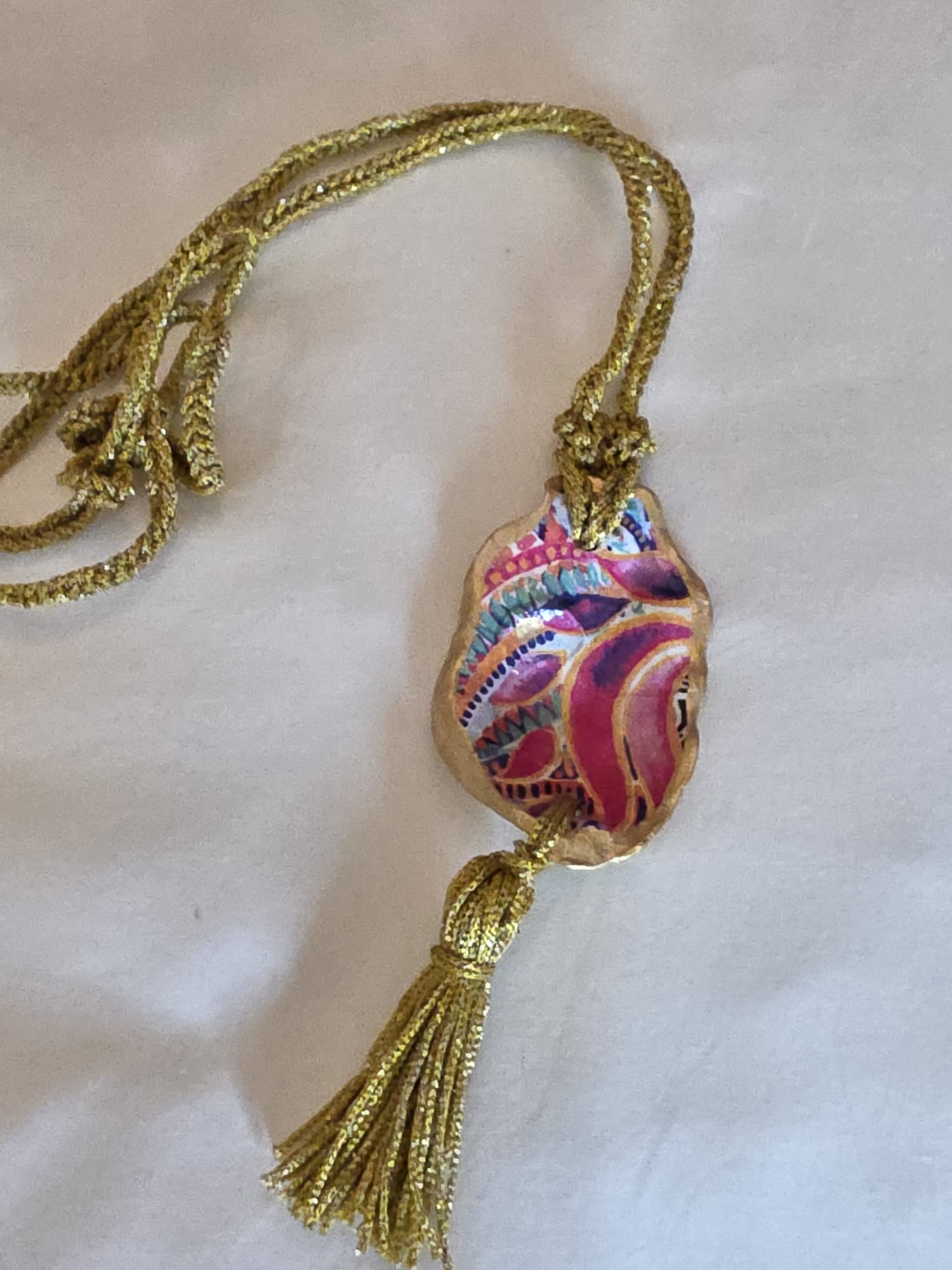 Collar artesanal con concha de ostión decorada con papel de arroz, cordón de ganchillo con hilo metalizado, pieza única inspirada en el Carvaval de Cádiz