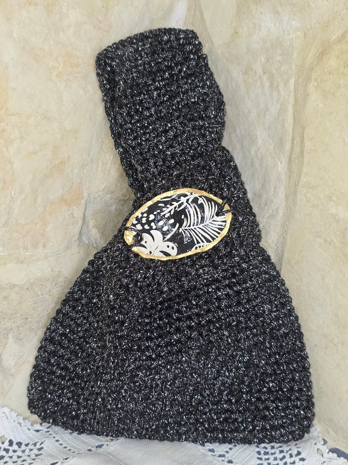 Bolso de ganchillo negro artesanal con hilo reciclado y concha decorativa. Diseño exclusivo