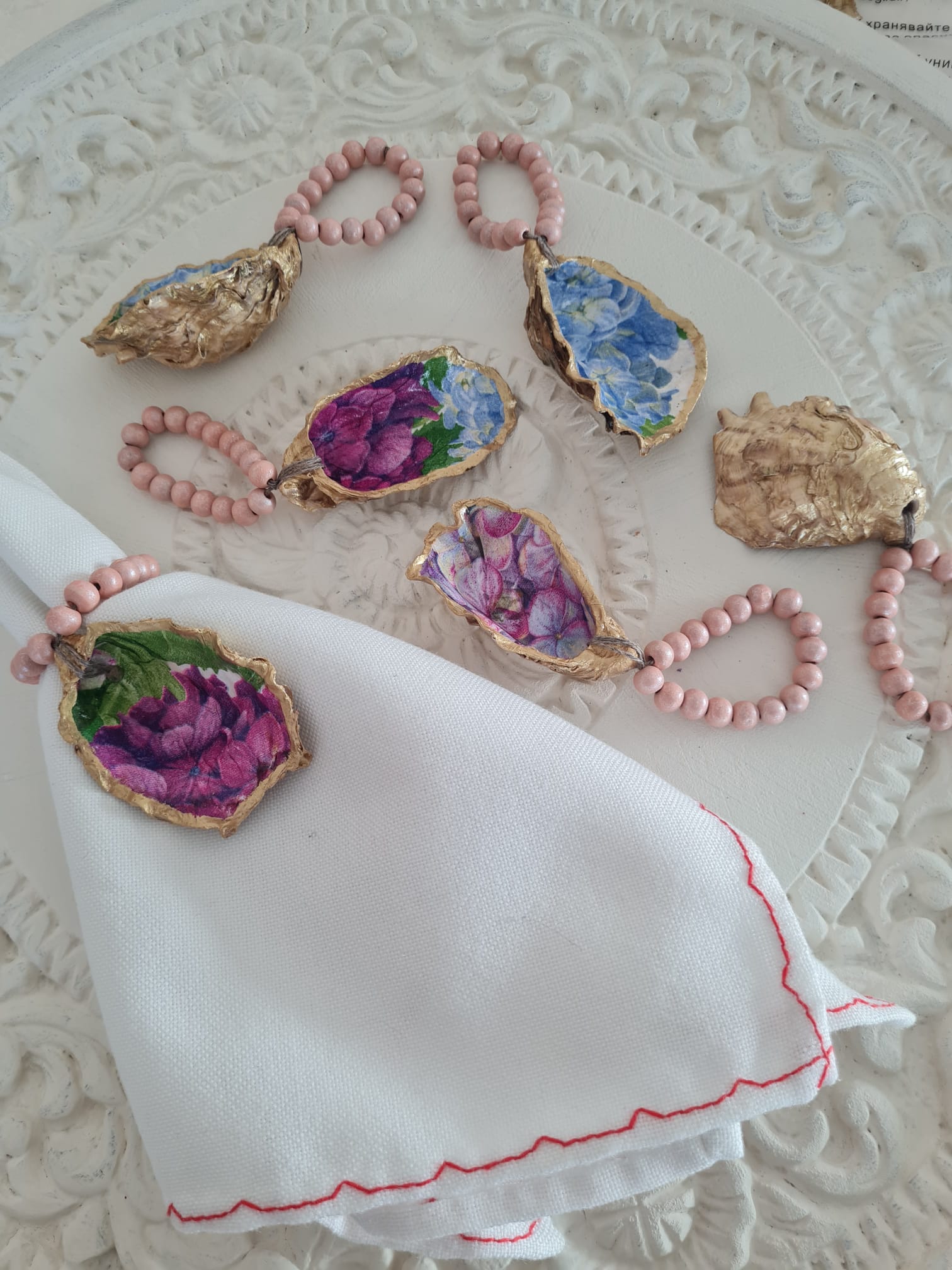 Servilletero artesanal de concha de ostión decorada con decoupage y cuentas de madera